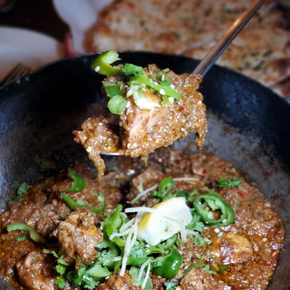 Karahi Boys - a hand holding a spoon full of food - Halal Near Me - Maple, Ontario Karahi Boys - a hand holding a spoon full of food - Halal Near Me - Maple, Ontario