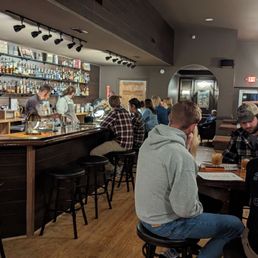 a group of people sitting at a bar