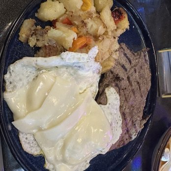 Fama Gastrobar - Steak and Eggs with Yuca Fries. Eggs were not cooked properly.Steak was not cooked properly. Requested medium well came out medium rare. - Gastropubs Near Me - Kissimmee, Florida