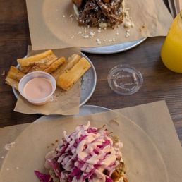 Pernil arepa, fried yuca, ropa vieja arepa, and parcha juice. Pernil arepa, fried yuca, ropa vieja arepa, and parcha juice.