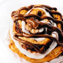 Peach Cobbler Factory-Stockbridge - A large, gourmet cinnamon roll packed with rich, imported cinnamon. Topped with white icing and Nutella drizzle.
