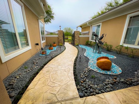 Beautiful Stone Garden and Pool Pebble Decoration - Extremely proud of this project, personally designed it myself. Pots contain aloe vera with a surrounding mix of succulents for anyone wondering. 
Give us a call today if you’re interested in getting your garden transformed like this!
