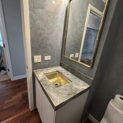 Precision Stone Design - New mirror, countertop, cabinet and sink. Note: Some work needs to be completed.
