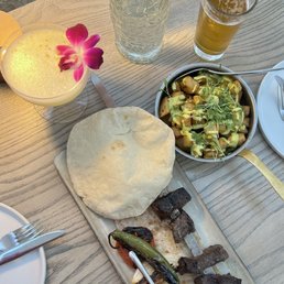 Wagyu Kebab and Batata Hara with Ambrosia cocktail which Wagyu Kebab and Batata Hara with Ambrosia cocktail which