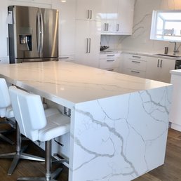 Waterfall island and countertops installed throughout. We are very happy with their work!