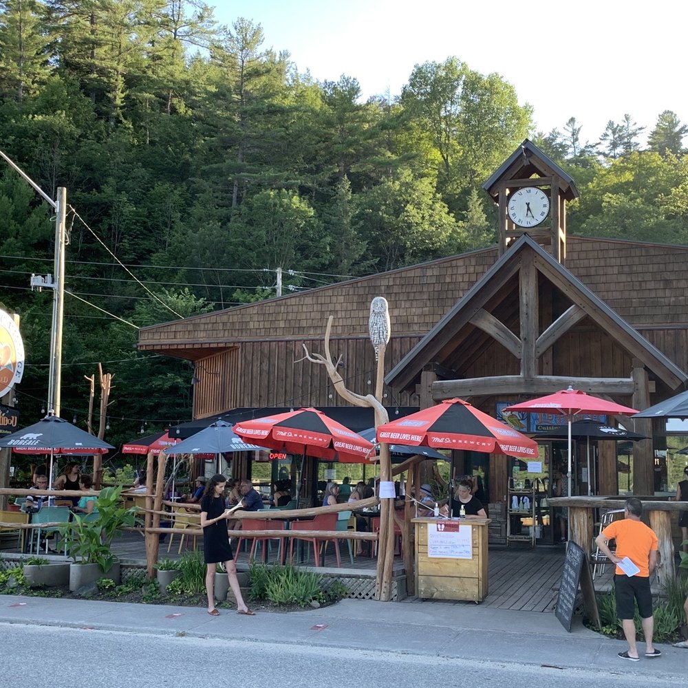 people standing outside of a restaurant people standing outside of a restaurant