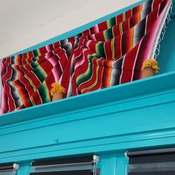 Above the entrance window in the dining room.
