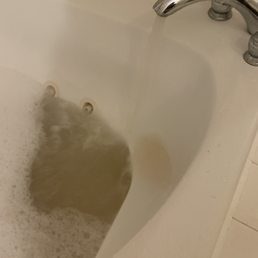 Rusty water going into the dirty tub. Rusty water going into the dirty tub.