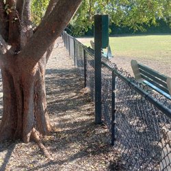 Poop bag dispenser facing large dog park