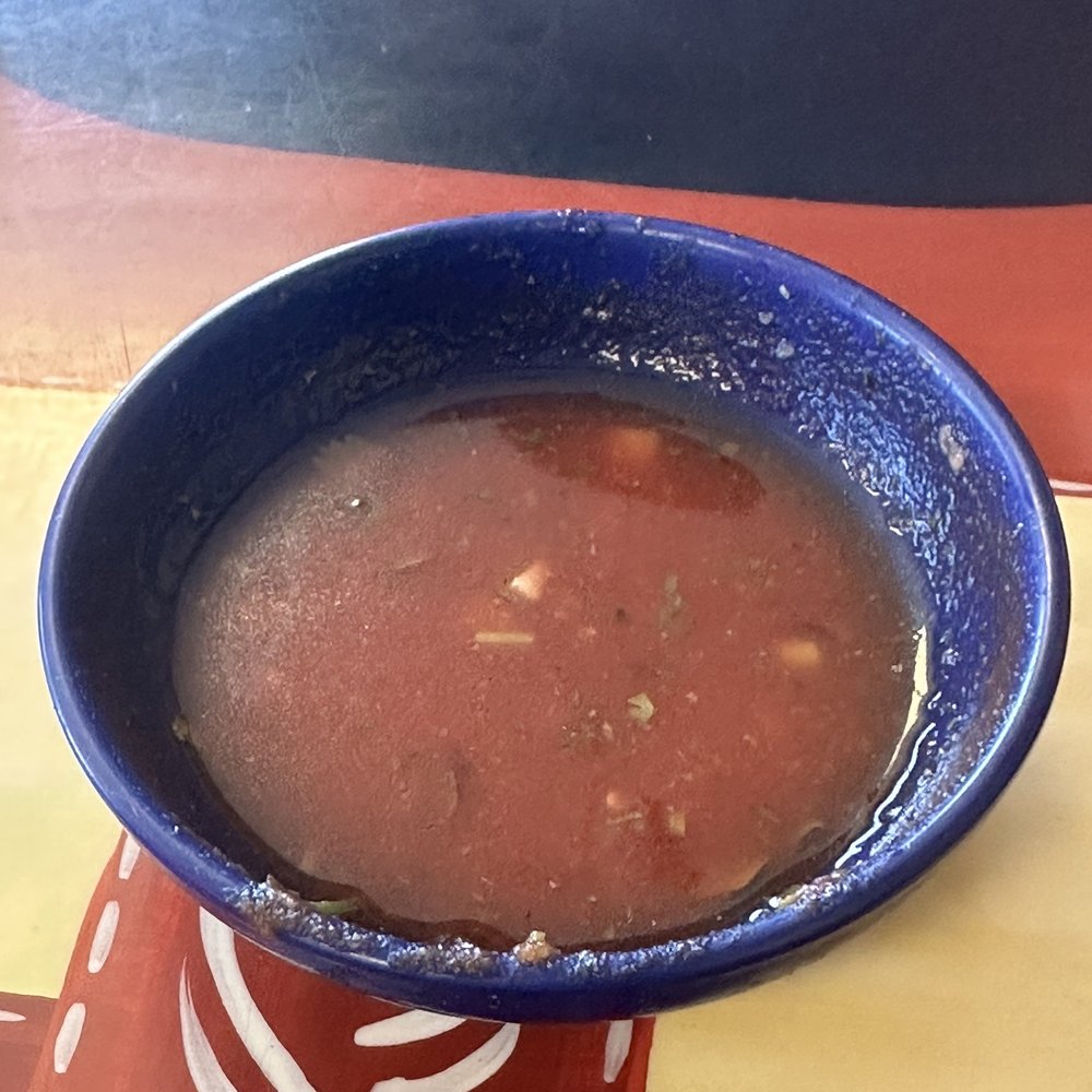 a bowl of soup on a table a bowl of soup on a table