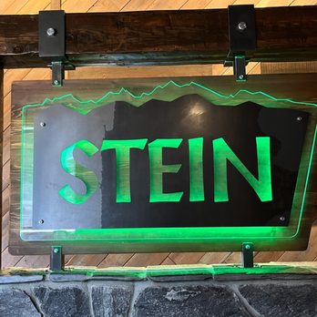 Stein - a man standing in front of a neon sign - Beer Bar Near Me - Leavenworth, Washington Stein - a man standing in front of a neon sign - Beer Bar Near Me - Leavenworth, Washington