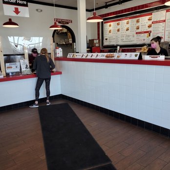 Firehouse Subs - a woman standing at the counter - Fast Food Near Me - Nampa, Idaho Firehouse Subs - a woman standing at the counter - Fast Food Near Me - Nampa, Idaho