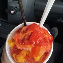 Mangonada knockout with mango chunks and mangonada ice, chile, chamoy