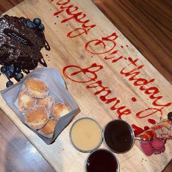 STK Steakhouse - Birthday spread  Cheesecake Chocolate Cake Bag O' Donuts - Steakhouses Near Me - Chicago, Illinois