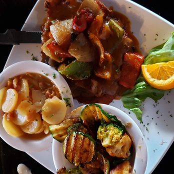 Cultures Grill & Bar - Pepper Schnitzel entree ($16.99) with German potato salad and grilled veggies. - American Near Me - Fredericksburg, Texas