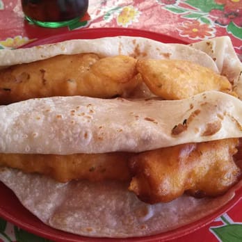 Mariscos la Alegria - 2 naked fish tacos.  Look at the size of that fish!!!!  Across a large flour tortilla - a two handed taco for $2. - Seafood Near Me - Rosarito, BCN