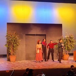 Newport High School - Drama Club stage production - Urinetown. The headquarters of the greedy "Urine Good Company", pronounced as you're in good company.