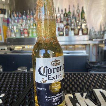 The Mining Company - a bottle of corona beer sitting on a bar - Gay Bars Near Me - Dallas, Texas The Mining Company - a bottle of corona beer sitting on a bar - Gay Bars Near Me - Dallas, Texas