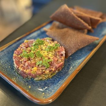 Meski Restaurant - Kitfo Tartare: Raw Beef Tenderloin w/ nitir kibbeh oil, cured egg yolk, chervil, injera chips ($19) - Ethiopian Near Me - San Francisco, California Meski Restaurant - Kitfo Tartare: Raw Beef Tenderloin w/ nitir kibbeh oil, cured egg yolk, chervil, injera chips ($19) - Ethiopian Near Me - San Francisco, California
