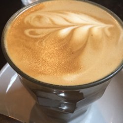 Nourish Cafe - Latte with a fern pattern.