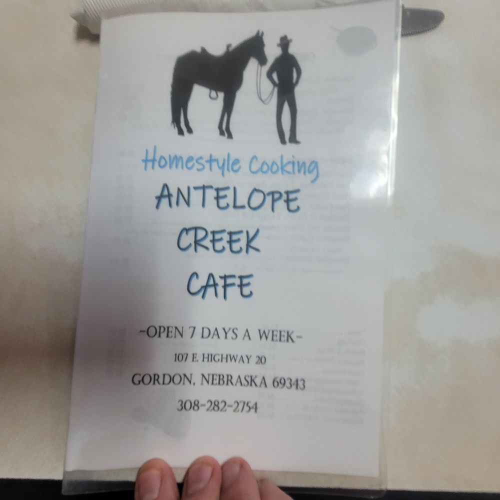 Antelope Creek Cafe - a hand holding a sign - American Near Me - Gordon, Nebraska Antelope Creek Cafe - a hand holding a sign - American Near Me - Gordon, Nebraska