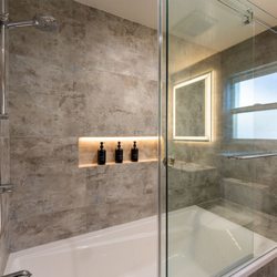 Lemon Remodeling and Services - bathroom construction, tile floor to ceiling, shampoo-niche, bath bench, glass shower door, modern bathroom design
