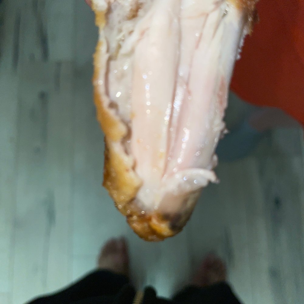 Wingstop - a person holding a half eaten chicken - Chicken Wings Near Me - Yuba City, California Wingstop - a person holding a half eaten chicken - Chicken Wings Near Me - Yuba City, California