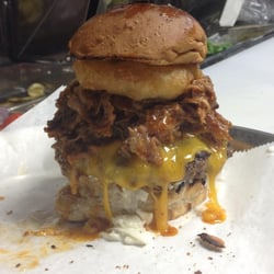 Stack House - Big Bailey Burger. A Cheddar cheese burger with cole slaw, pickle, pulled pork drenched in our homemade Beer-B-Q sauce, and and Onion ring