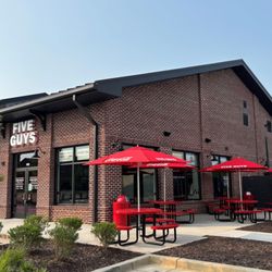 Exterior photograph of the Five Guys restaurant at 6135 Ollie Walk in Alpharetta, Georgia.