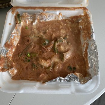 Cafe Strudel - Ridiculously soupy shrimp and grits placed in a clamshell container. - New American Near Me - West Columbia, South Carolina