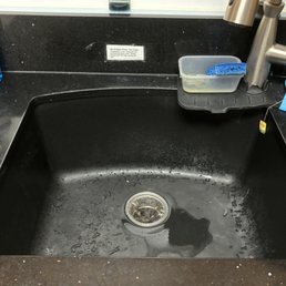 Graphite sink with mineral deposit stains. Before Aaron. Our water is very "hard".