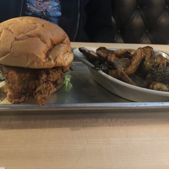 Christies - Spicy crispy chicken sandwich with the potato and brussels side! The chicken was hot, crispy, and juicy on the inside! - Sports Bars Near Me - Dallas, Texas Christies - Spicy crispy chicken sandwich with the potato and brussels side! The chicken was hot, crispy, and juicy on the inside! - Sports Bars Near Me - Dallas, Texas