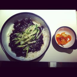 cha chang myun served with a side of kimchi