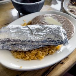 Foil-wrapped Flour tortillas, Refried beans and rice. (2nd plate of my Carne Asada)
