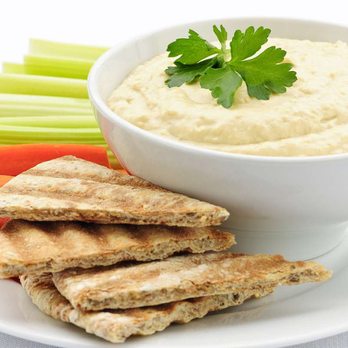 Halal Empire - a bowl of hummus and crackers - Mediterranean Near Me Halal Empire - a bowl of hummus and crackers - Mediterranean Near Me