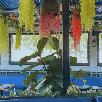 Octopus Kitchen - Hanging flowers on the covered patio - Seafood Near Me - Atlanta, Georgia Octopus Kitchen - Hanging flowers on the covered patio - Seafood Near Me - Atlanta, Georgia