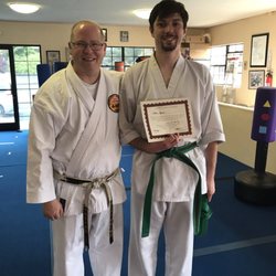 Freeman's Shorin-Ryu Karate - Sensei Kelly awarding a green brown belt after a test
