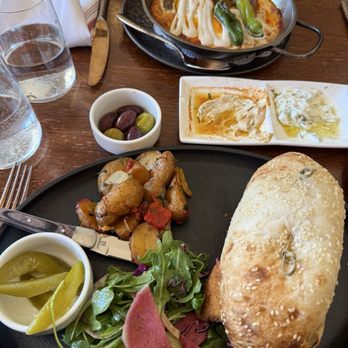Frena - Merguez shashuka on top and chicken schnitzel on bottom - Mediterranean Near Me - New York, New York Frena - Merguez shashuka on top and chicken schnitzel on bottom - Mediterranean Near Me - New York, New York