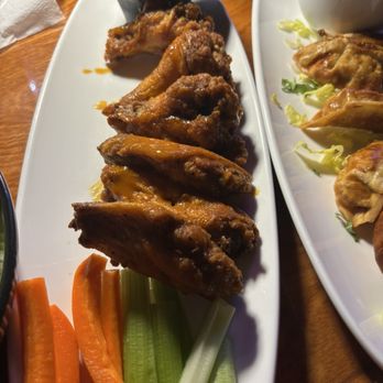 Monarch Bar and Lounge - Chicken wings with mild sauce and potstickers. - Bars Near Me - Houston, Texas