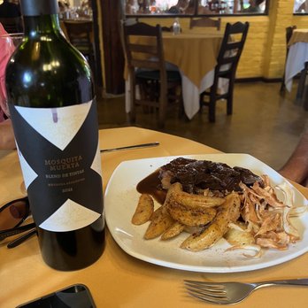 La Rueda 1975 - Bife chorizo with a Malbec wine reduction sauce. Also outstanding Argentine wine blend, Mosquito Muerto - Argentine Near Me - Puerto Iguazú, N