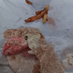 Lee's Hoagie House - A wheat wrap with grilled chicken mozzarella cheese and mayonnaise and honey mustard and some burnt French fries