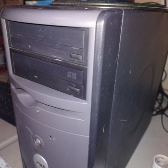 Computer Guy'z - You can buy this for $25 - A Dell desktop computer tower with a DVD drive, showing signs of wear, dust, and scratches, placed on a cluttered surface. - IT Services & Computer Repair Near Me