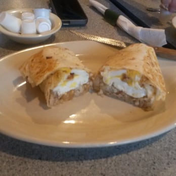 Tex-Mex Joe's - Messycan burrito has fried eggs, tater tots, cheese and bacon or sausage. - Tex-Mex Near Me - Austin, Texas
