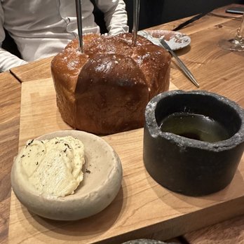 Beaver Hall - a loaf of bread and butter on a cutting board - Steakhouses Near Me - Montreal, Quebec