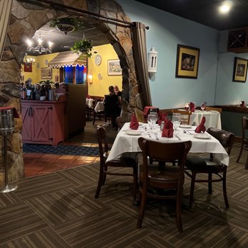 Miguel's Restaurant - a dining room with tables and chairs - French Near Me - Sarasota, Florida
