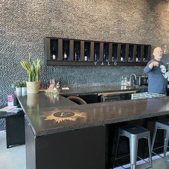 Valo - a man standing at a bar - Wine Tasting Room Near Me - Vancouver, Washington