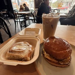 Cinnamon roll, belly up and a vanilla latte. Cinnamon roll, belly up and a vanilla latte.