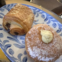 Pain au chocolat (left) and Bombolone Crema (right). Pain au chocolat (left) and Bombolone Crema (right).