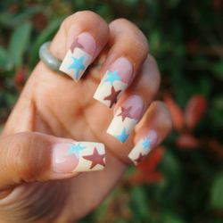 Butter yellow French tip with brown and blue stars.