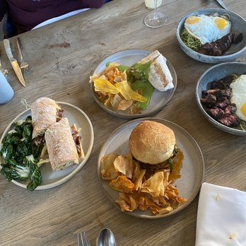 Llama Inn - Left- prime rib sandwich middle- breakfast burrito and charred calamari sandwich right- steak and eggs and pesto pasta - Peruvian Near Me - Brooklyn, New York